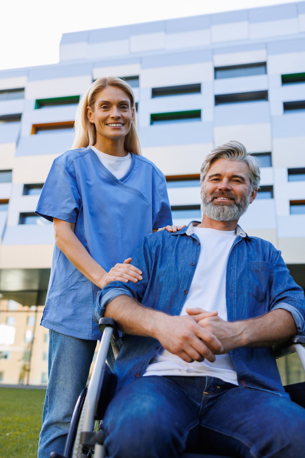 A caregiver supporting an older adult in a wheelchair